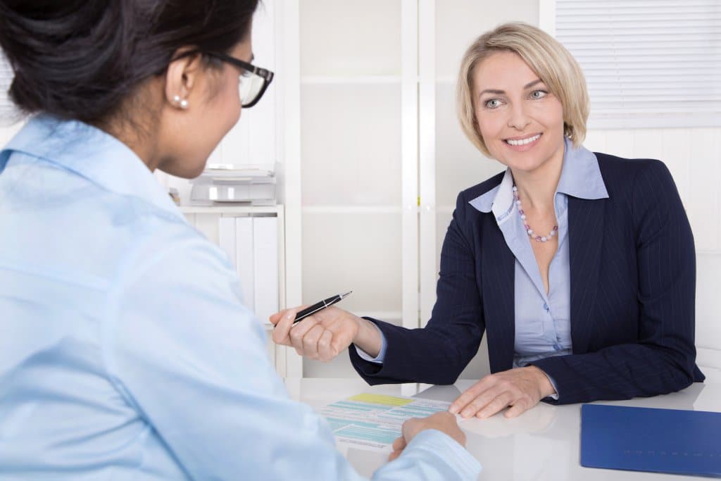 26099529_xl-two-women-talking-office