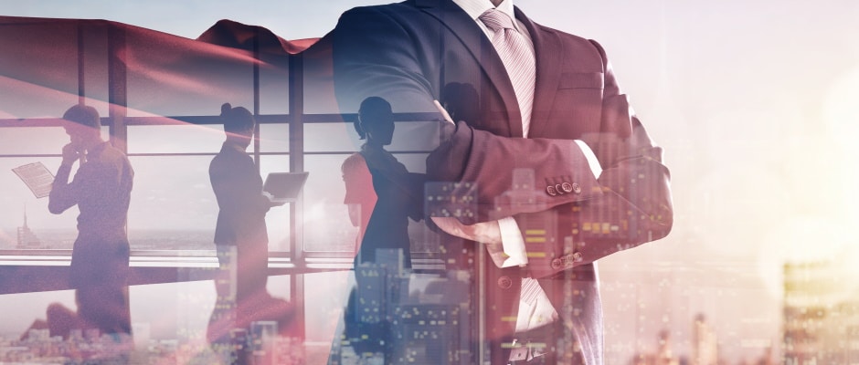 superhero businessman looking at city skyline at sunset. the concept of success, leadership and victory in business.