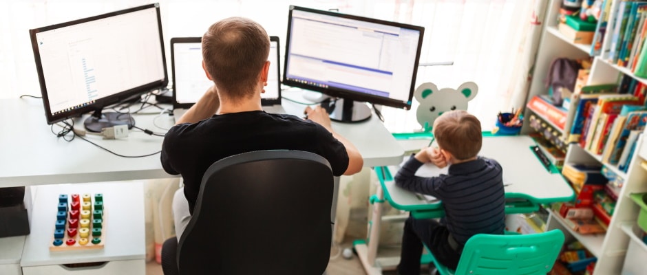 Father with kid trying to work from home during quarantine. Stay at home, work from home concept during coronavirus pandemic
