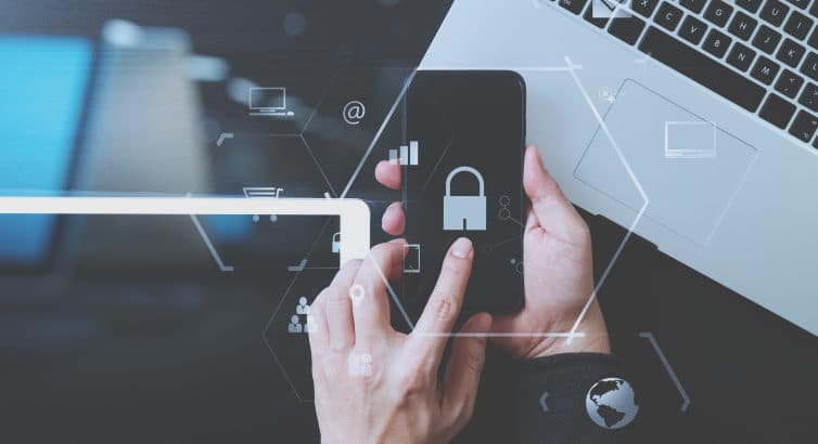 cyber security internet and networking concept.Businessman hand working with VR screen padlock icon mobile phone on laptop computer and digital tablet