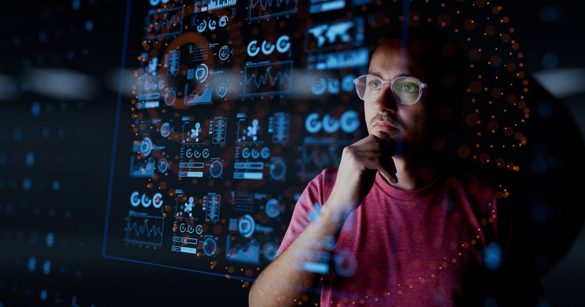 Homem de óculos e camiseta vermelha observa atentamente uma grande tela transparente cheia de gráficos, métricas e dados digitais em tons de azul e laranja, representando análise de dados, métricas de negócios e tecnologia B2B erros, eficiencia