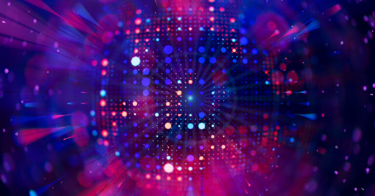 Imagem abstrata com efeito de luzes coloridas em tons de azul, roxo, rosa e vermelho, formando um padrão circular que remete a tecnologia, computação ou dados digitais, com vários pontos luminosos espalhados e linhas que convergem para o centro da imagem (computação quântica)