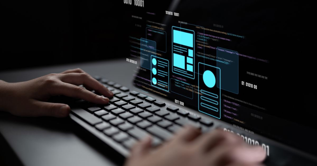 A imagem mostra um teclado sendo utilizado por uma pessoa, com uma tela digital projetando elementos gráficos e códigos. Detalhes principais: Primeiro plano: Mãos digitando em um teclado, sugerindo atividade de programação ou desenvolvimento. Tela projetada: Exibe códigos em linguagem de programação e elementos de interface (UI) como caixas, ícones e layouts, indicando design e desenvolvimento de aplicações ou sites. Cores e estilo: Fundo escuro com destaques em azul neon para os elementos gráficos, transmitindo uma estética tecnológica e futurista. Contexto: Representa claramente um cenário de desenvolvimento digital, programação e inovação tecnológica. (BRQ) Forrester