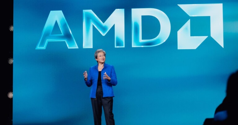 Lisa Su, CEO da AMDA, palestrando em conferência da AMD apresentando avanços em inteligência artificial, processadores, GPUs e computação de alto desempenho, com o logotipo da empresa em destaque no palco.